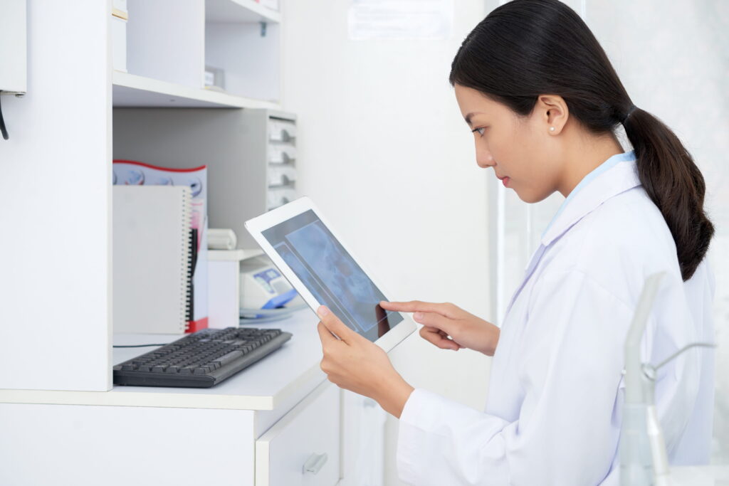 A doctor checking the results of a diagnostic test through a tablet.