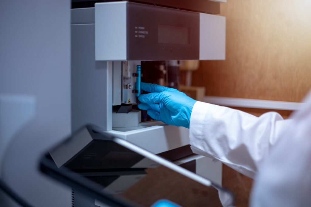 Close up image of a person conducting preventive maintenance on analytical equipment.