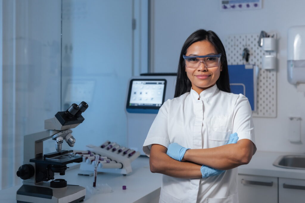 Young female medical technologist standing in a clinical laboratory