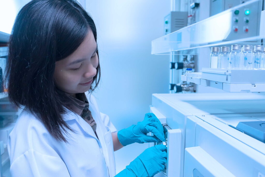 A female medical professional operating a lab equipment.